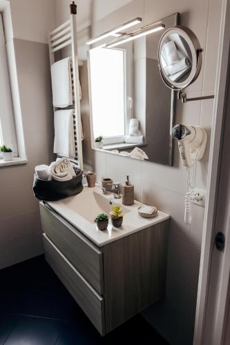 a bathroom with a sink and a mirror at Villa Erasi in Fiumicino