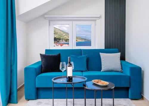 a blue couch in a living room with a table at Hotel SOL in Bol
