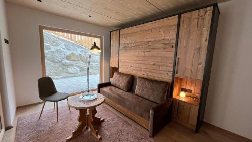 a room with a couch and a table and a chair at Quartier Severin in Berwang