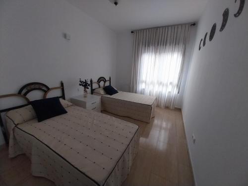 a living room with two beds and a couch at Estancia San Francisco in Calatayud