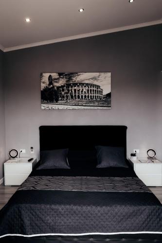a bedroom with a large bed with two night stands at Villa Erasi in Fiumicino
