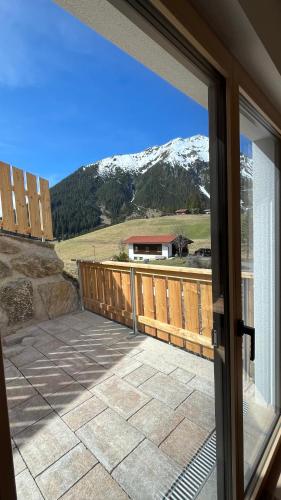a door to a balcony with a view of a mountain at Quartier Severin in Berwang