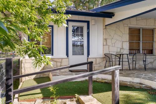 a house with a porch with a table and chairs at Waterlily Creekside Serenity in Wimberley