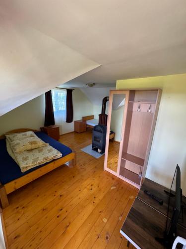 a bedroom with a bed and a mirror in a room at Ela’s retreat in Dealu Mare
