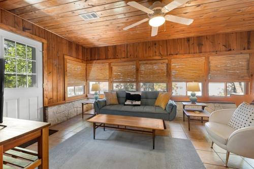 a living room with a couch and a ceiling fan at Waterlily Creekside Serenity in Wimberley