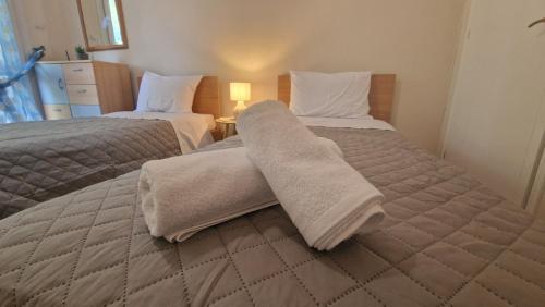 a bedroom with two beds with towels on them at Modern Sea Villa in Leptokaria in Leptokaria