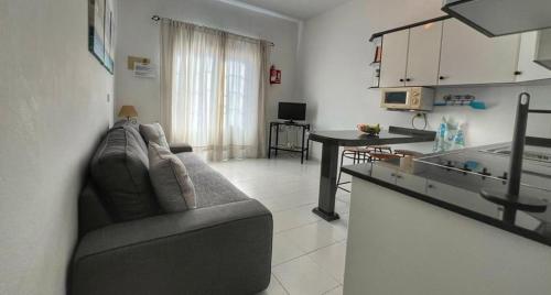 a living room with a couch and a table at Sombrerito 1 in Caleta de Sebo