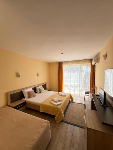 Postel nebo postele na pokoji v ubytování Hotel Damyanoff