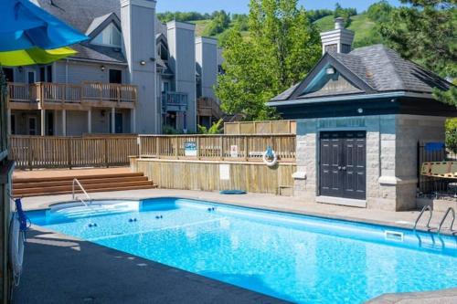 a swimming pool in front of a house at Mountainside Retreat in Blue Mountains