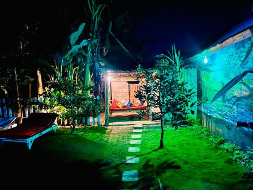 a garden at night with a bench in the yard at Arusha Jua Eco Home- on coffee farm in Arusha