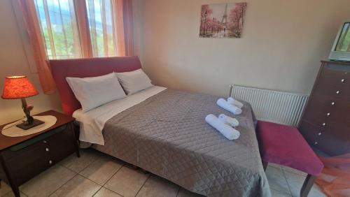 a small bedroom with a bed with two towels on it at Modern Sea Villa in Leptokaria in Leptokaria