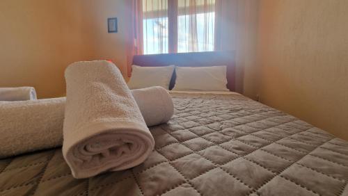 a bedroom with a bed with towels on it at Modern Sea Villa in Leptokaria in Leptokaria