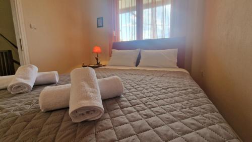a bedroom with a large bed with towels on it at Modern Sea Villa in Leptokaria in Leptokaria