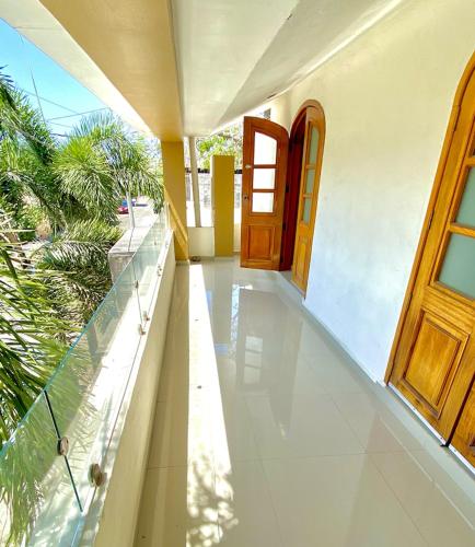 an empty porch of a house with a door at Residencia Las Palmas in Colima