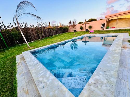 a swimming pool in the yard of a house at DAR MAÏSSA in Asilah