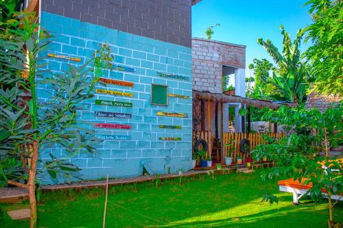 a blue brick building with a sign on it at Arusha Jua Eco Home- on coffee farm in Arusha