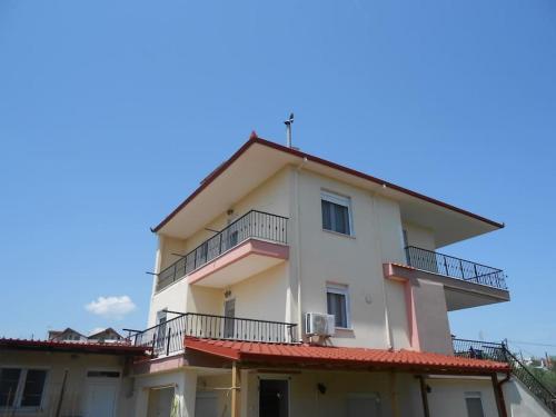 a white building with balconies on top of it at Villa Mary in Makrýgialos