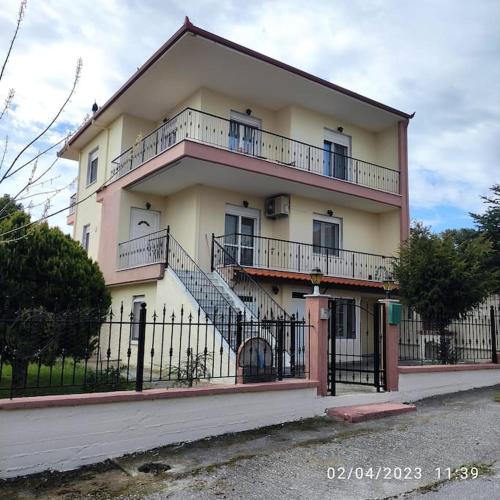 a large building with a staircase in front of it at Villa Mary in Makrýgialos