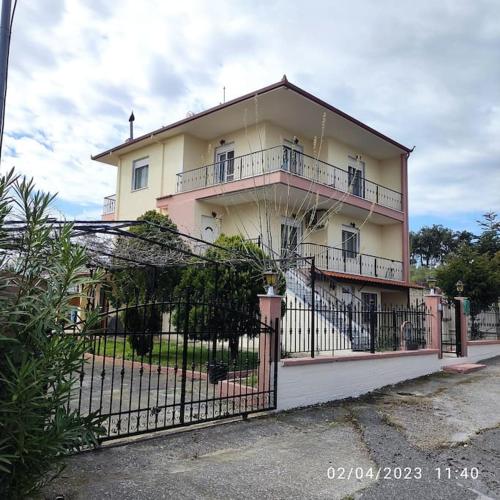 a large building with a fence in front of it at Villa Mary in Makrýgialos
