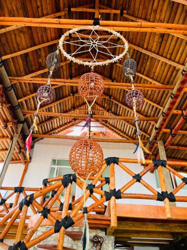 a wooden ceiling with chandeliers hanging from it at Villas Coco Mare in Acapulco