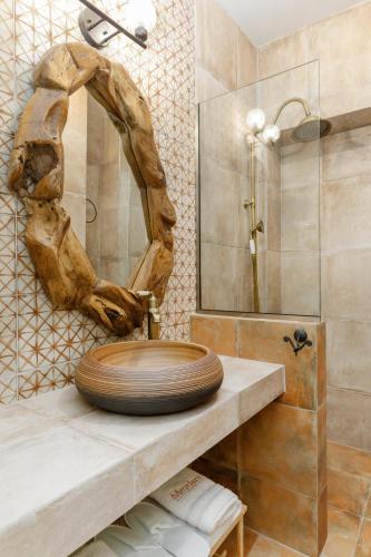 a bathroom with a toilet on a counter with a mirror at Meydani Suites in Litochoro