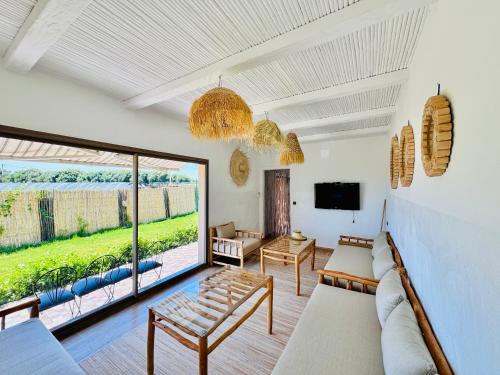 a living room with a couch and a large window at DAR MAÏSSA in Asilah