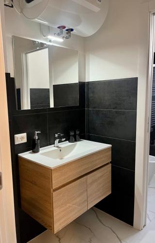 a bathroom with a sink and a mirror at Dimora Chic - A 5 Fermate Dal Duomo in Milan