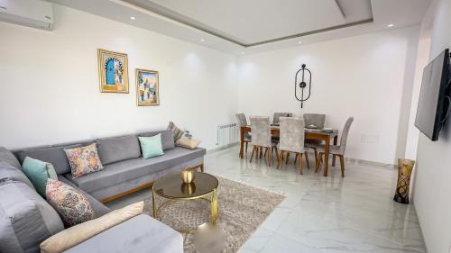 a living room with a couch and a table at Jasmin Villas Djerba in Mezraya