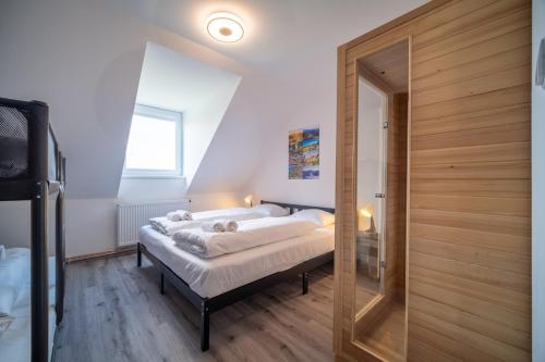 A bed or beds in a room at Vila Magda - Lipno Home