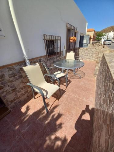two chairs and a table on a patio at Casa Caremy in Almería