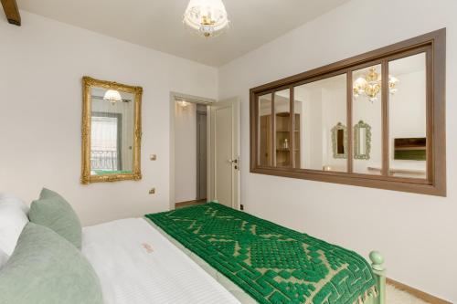a bedroom with a bed and a mirror on the wall at Meydani Suites in Litochoro