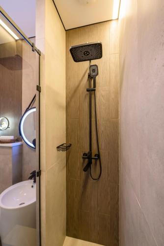 a shower in a bathroom with a sink at Five Business-class rooms in R-house near Mega Center Almaty in Almaty