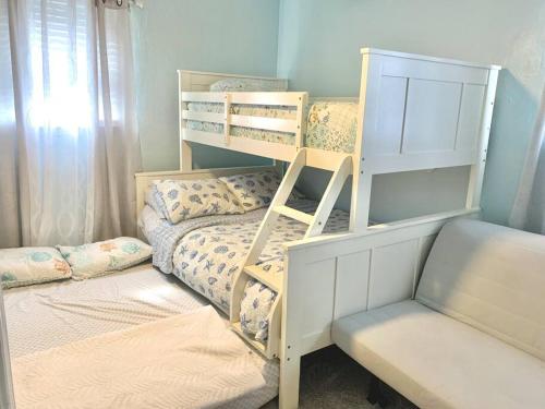a bedroom with two bunk beds and a couch at Virginia Beach 2Story with Pool in Virginia Beach