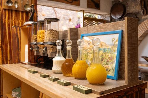 a shelf with a bunch of glass bottles on it at Terra Minoika Boutique Resort in Káto Zákros