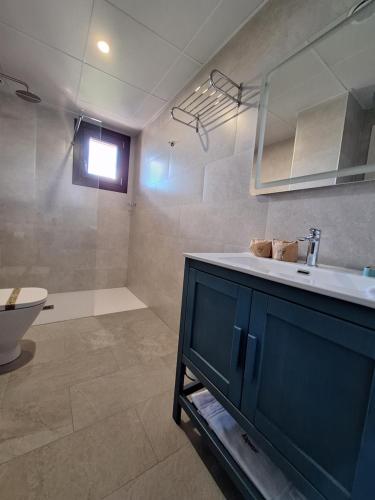 a bathroom with a sink and a toilet and a tub at Hotel Vinoteca Alquezar - Adults Only - in Alquézar