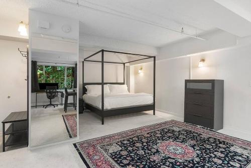 a bedroom with a bed with a mirror and a desk at Starlit Cozy Studio in Elektra with Roof Decks in Seattle