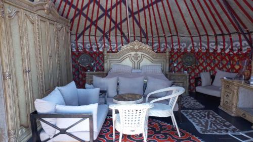 a bedroom with a bed and a table and chairs at Ak-Tengir Yurt Resort in Tossor