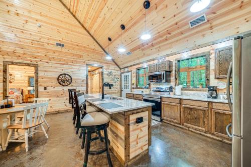 a kitchen with wooden walls and a wooden ceiling at Near Choctaw Casino Broken Bow Cabin with Hot Tub! in Broken Bow