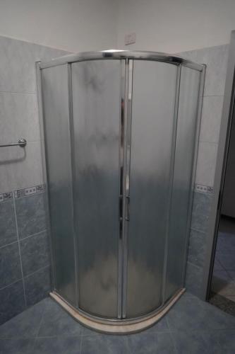 a shower with a glass door in a bathroom at Hotel Restaurant Globi in Velipojë