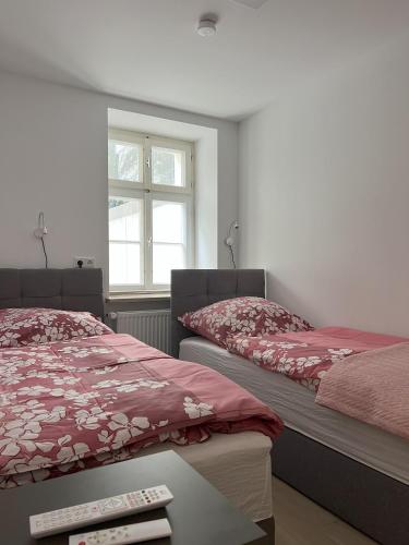 a bedroom with two beds and a window at Ferienresidenz Villa Augusta in Bad Salzuflen