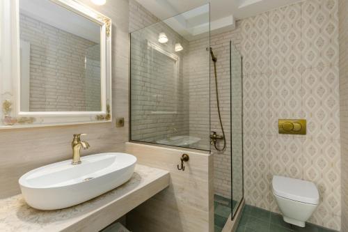 a bathroom with a sink and a glass shower at Meydani Suites in Litochoro