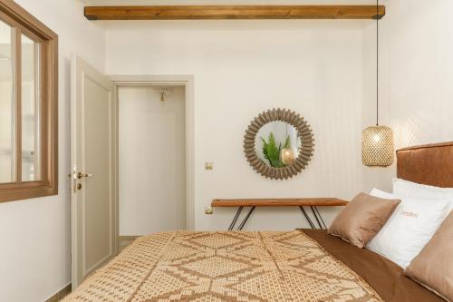 a bedroom with a bed and a mirror on the wall at Meydani Suites in Litochoro