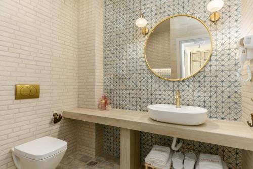 a bathroom with a sink and a mirror at Meydani Suites in Litochoro