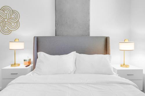 a bedroom with a white bed with two lamps at The Nomad Roosevelt in Phoenix