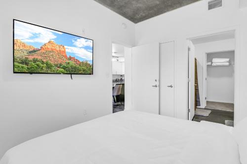 a white room with a tv on a wall at The Nomad Roosevelt in Phoenix