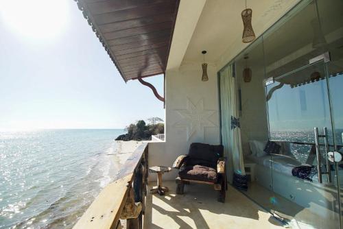a balcony of a house overlooking the water at Royal Cliff Zanzibar in Zanzibar City