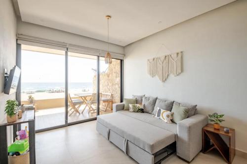 a living room with a couch and a view of the ocean at Oceanfront condo with terrace in San Francisco