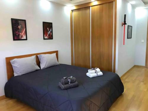 a bedroom with a large bed with towels on it at Hollywood Apartment in Bragança
