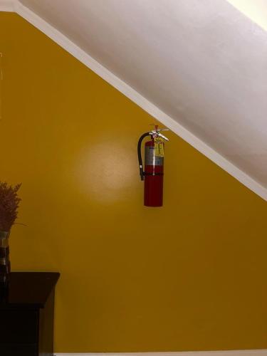 a fire extinguisher hanging on the wall of a room at palmview estate townhouse in Mammee Bay