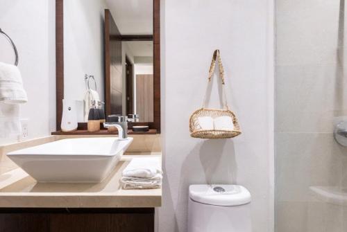 a bathroom with a sink and a toilet and a mirror at Oceanfront condo with terrace in San Francisco